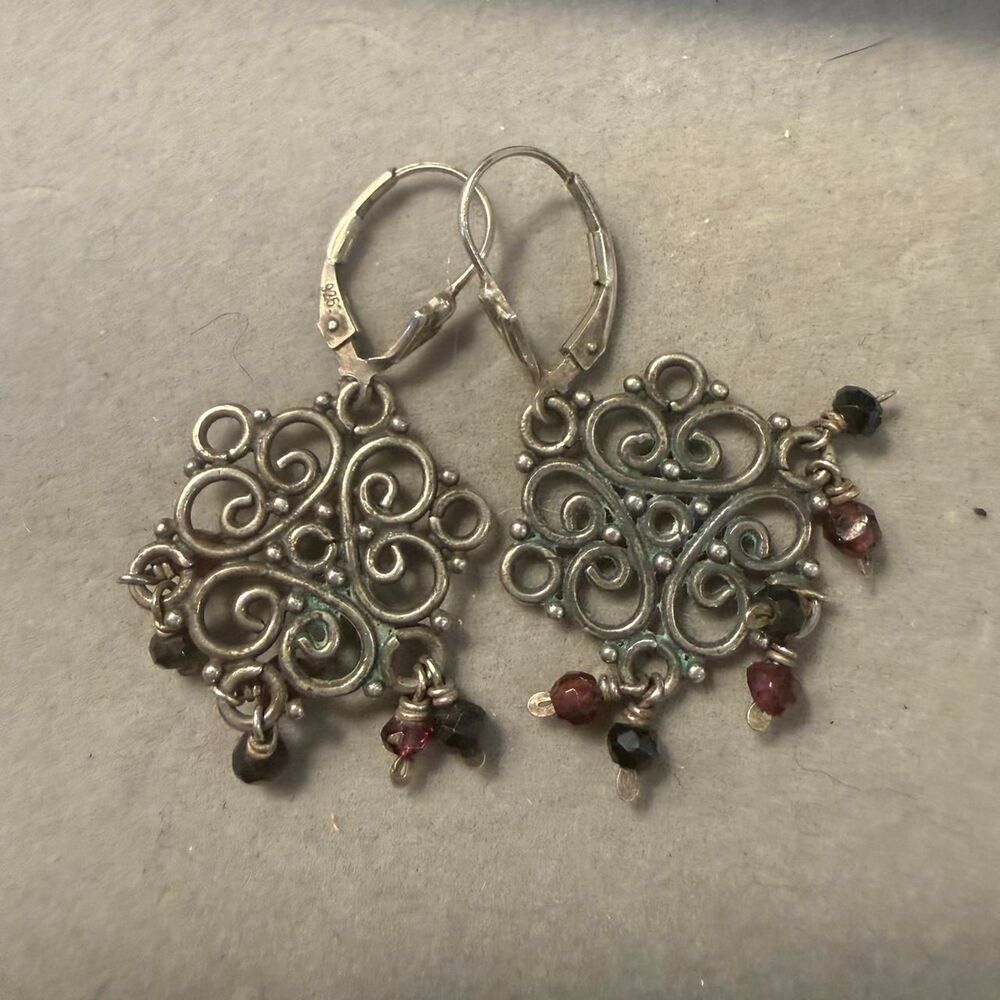 Sterling silver earrings with red garnet beads and intricate scrollwork